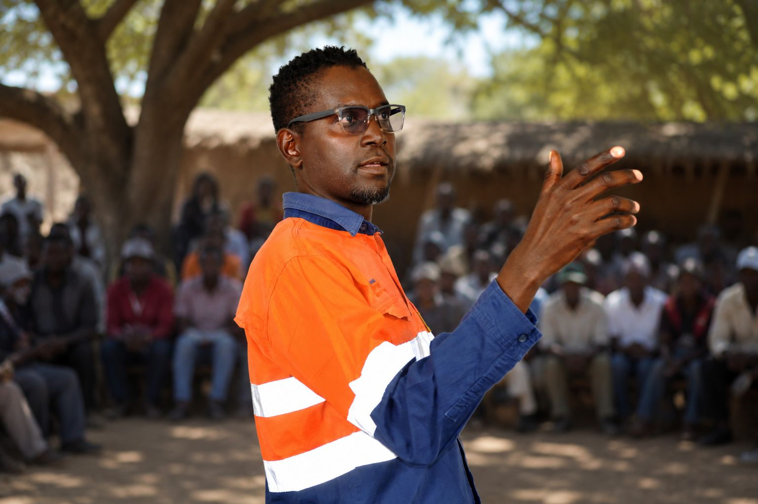 Community liaison representative addressing a community gathering